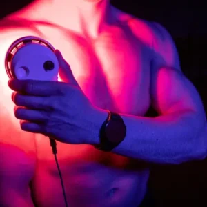 A man holding a SuperPalm light therapy device in his hands.